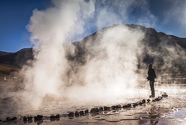 Tourist at El Tatio Geysers (Geysers del Tatio), the largest geyser field in the Southern Hemisphere, Atacama Desert, Chile, South America