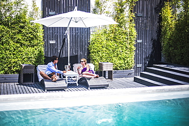 Couple on holiday by a swimming pool, Santiago, Chile, South America