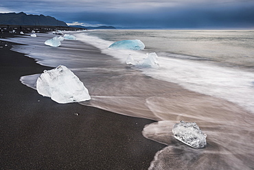 Icebergs at sunrise on Jokulsarlon Beach, a black volcanic sand beach in South East Iceland, Iceland, Polar Regions