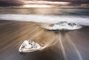 Icebergs at sunrise on Jokulsarlon Beach, a black volcanic sand beach in South East Iceland, Iceland, Polar Regions