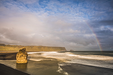 Reynisdrangar Basalt Sea Stacks and rainbow seen from Dyrholaey Peninsula at sunset, near Vik, South Iceland (Sudurland), Iceland, Polar Regions