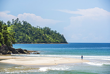 Tourist walking on Sungai Pinang Beach, near Padang in West Sumatra, Indonesia, Southeast Asia, Asia