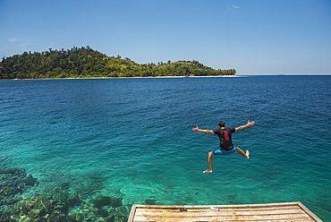 Tourist jumping into the Pacific Ocean at Twin Beach, a tropical white sandy beach near Padang in West Sumatra, Indonesia, Southeast Asia, Asia