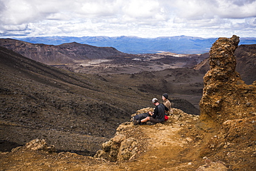 Couple resting on the Tongariro Alpine Crossing, Tongariro National Park, UNESCO World Heritage Site, North Island, New Zealand, Pacific