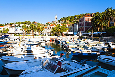 Hvar town centre, boats in Hvar harbour and church bell tower, Hvar Island, Dalmatian Coast, Adriatic, Croatia, Europe