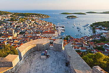 Hvar Town and tourists at Hvar Spanish Fort (Fortica) at sunset, Hvar Island, Dalmatian Coast, Adriatic, Croatia, Europe 