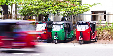 A tuk tuk speeding through the streets, Anuradahapura, North Central Province, Sri Lanka, Asia 