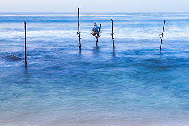 Stilt fisherman fishing at Midigama near Weligama, South Coast, Sri Lanka, Indian Ocean, Asia