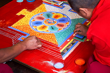 Buddhist monks making a diorama (mandala) with coloured sand, which once made is wiped off to demonstrate transience and impermanence, Bhutan, Asia