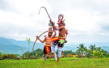 Caci men perform a traditional whip dance with bamboo shields and leather whips, western Flores, Indonesia, Southeast Asia, Asia