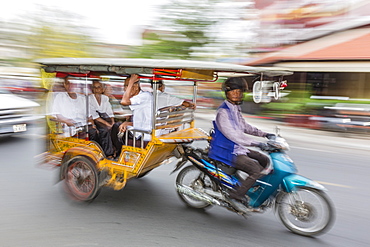 Motion blur image of a tuk-tuk in the capital city of Phnom Penh, Cambodia, Indochina, Southeast Asia, Asia 