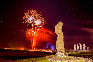 Fireworks ring in the New Year from the town of Hanga Roa over moai in the Tahai Archaeological Zone on Easter Island (Isla de Pascua) (Rapa Nui), UNESCO World Heritage Site, Chile, South America