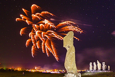 Fireworks ring in the New Year from the town of Hanga Roa over moai in the Tahai Archaeological Zone on Easter Island (Isla de Pascua) (Rapa Nui), UNESCO World Heritage Site, Chile, South America