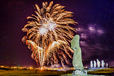 Fireworks ring in the New Year from the town of Hanga Roa over moai in the Tahai Archaeological Zone on Easter Island (Isla de Pascua) (Rapa Nui), UNESCO World Heritage Site, Chile, South America