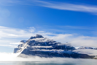 Fog lifting on the steep cliffs of Icy Arm, Baffin Island, Nunavut, Canada, North America 