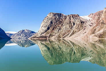 Reflections on a calm sea of the steep cliffs of Icy Arm, Baffin Island, Nunavut, Canada, North America 