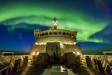 Aurora borealis (Northern Lights) dance above the Lindblad Expeditions ship National Geographic Explorer in Hudson Strait, Nunavut, Canada, North America