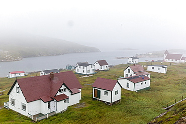 Fog rolls in over the small preserved fishing village of Battle Harbour, Labrador, Canada, North America 