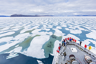 The Lindblad Expeditions ship National Geographic Explorer in Shorefast ice, Maxwell Bay, Devon Island, Nunavut, Canada, North America