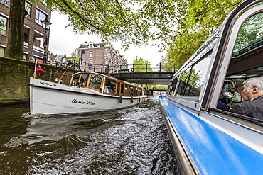 Canal boat ride through downtown, Amsterdam, Netherlands, Europe