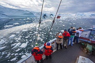 A commercial iceberg tour amongst huge icebergs calved from the Ilulissat Glacier, UNESCO World Heritage Site, Ilulissat, Greenland, Polar Regions