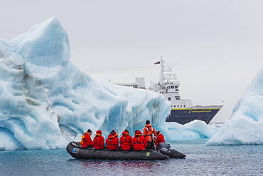 Lindblad Expeditions guests in a Zodiac approach a glacial iceberg at Brown Bluff, Weddell Sea, Antarctica, Polar Regions