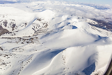 Aerial view of mountains, glaciers and ice fields on the west coast of Spitsbergen on a commercial flight from Longyearbyen to Oslo, Svalbard, Norway, Scandinavia, Europe