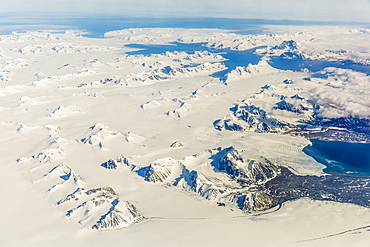 Aerial view of mountains, glaciers and ice fields on the west coast of Spitsbergen on a commercial flight from Longyearbyen to Oslo, Svalbard, Norway, Scandinavia, Europe