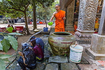 Buddhist monk offers water blessing near Prasat Bayon, Angkor Thom, Angkor, Siem Reap Province, Cambodia, Indochina, Southeast Asia, Asia