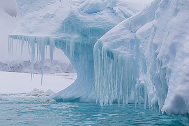 Wind and water sculpted iceberg with icicles at Booth Island, Antarctica, Polar Regions