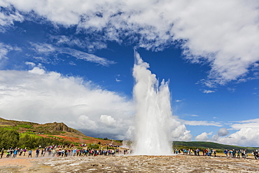 Tourists gather to watch Strokker geyser (geysir), an erupting spring at Haukadalur, Iceland, Polar Regions