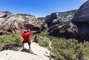 Photographer shooting the valley floor from Angel's Landing Trail in Zion National Park, Utah, United States of America, North America