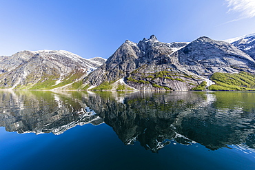 Snow-capped mountains reflected in the calm waters of Nordfjord, deep inside of Melfjord, Norway, Scandinavia, Europe