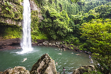 Tourists enjoy the refreshing cool waters of a waterfall on Taveuni Island, Republic of Fiji, South Pacific Islands, Pacific