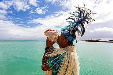 A conch shell blowing warrior welcoming guests to Aitutaki, Cook Islands, South Pacific Islands, Pacific