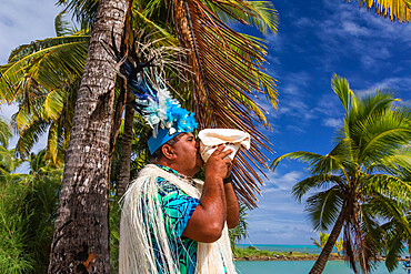 A conch shell blowing warrior welcoming guests to Aitutaki, Cook Islands, South Pacific Islands, Pacific