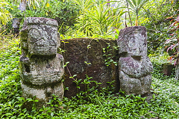 Twin tikis marking the Christian gravesite of Te hau moe in Puama'u, Hiva Oa, Marquesas, French Polynesia, South Pacific, Pacific