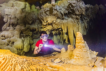 A snorkeler explores the fresh water grotto formations at Makatea, Tuamotus, French Polynesia, South Pacific, Pacific