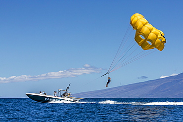 Visitors parasailing in the AuAu Channel, Maui, Hawaii, United States of America, Pacific