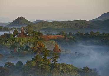 View over the hills and pagodas in the evening mist at Mrauk U, Myohaung north of Sittwe, Akyab, Rakhine State, Arakan, Myanmar, Burma