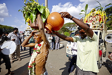 Pilgrim carrying holy water on his head, Mysore, Karnataka, India