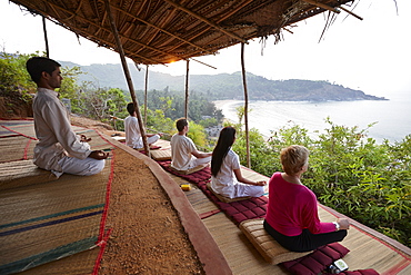 Meditation before sunrise above Om beach, Gokarna, Karnataka, India
