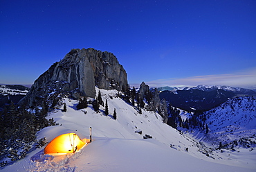 Illuminated tent in front of mount Risserkogel, Plankenstein in background, Bavarian Prealps, Upper Bavaria, Germany