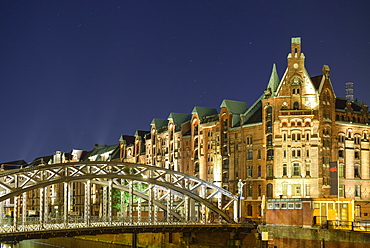 Illuminated bridge Brooksbruecke with Warehouse district in the background, Warehouse district, Speicherstadt, Hamburg, Germany