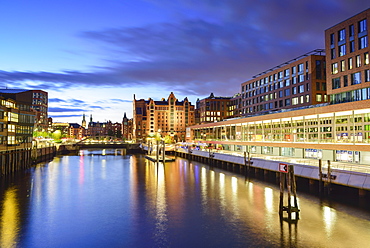 Illuminated port Magdeburger Hafen with warehouse district in the background, Hafencity, Hamburg, Germany