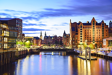 Illuminated port Magdeburger Hafen with warehouse district in background, Hafencity, Hamburg, Germany