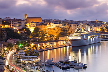 Cruise ship MS Deutschland (Reederei Peter Deilmann) at the pier and old town buildings at dusk, Mahon, Menorca, Balearic Island