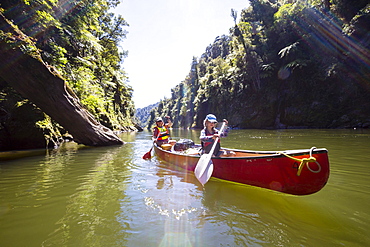 A girl and a woman on a canoe trip on the Whanganui River, North Island, New Zealand