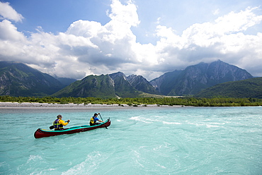 Canoeing on the blue waters of the Talgliamento, Tolmezzo, Italy