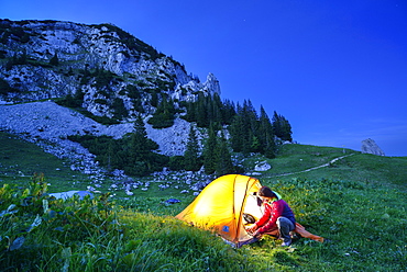 Woman in front of a tent, Rossstein, Bavarian Prealps, Upper Bavaria, Bavaria, Germany